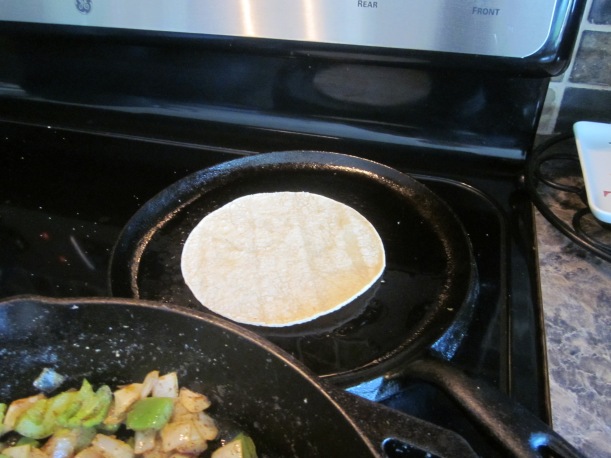 Tortillas warming on a comal, or Mexican griddle pan.