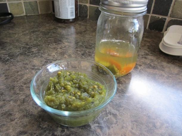 Diced jalapenos with homemade pickled jalapenos in the background